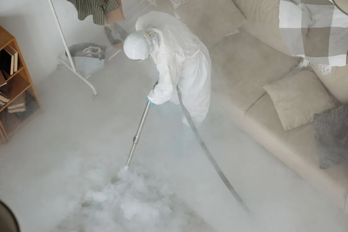 Biohazard cleanup technician in protective equipment, Laureldale, PA
